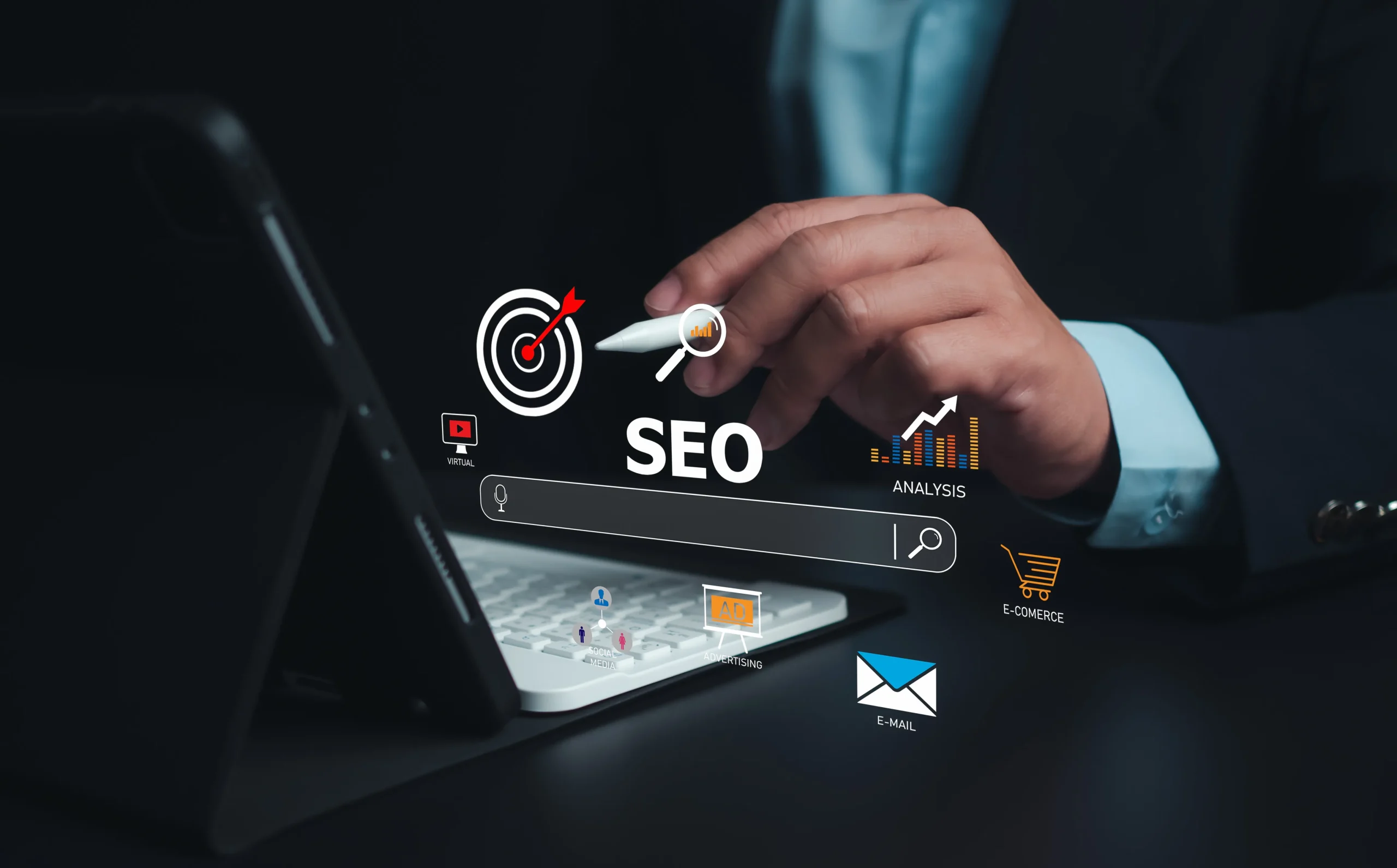 A person uses a stylus on a tablet, with floating SEO icons and terms like "analysis" and "e-commerce" symbolizing digital marketing concepts. mintdigitalsolutions